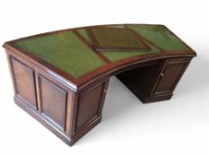 A contemporary stained-oak knee-hole desk with gre