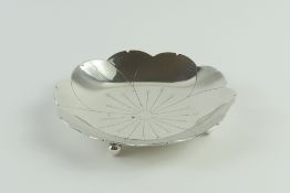 A small silver dish in the form of a flower