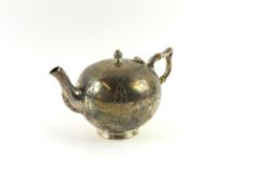 A small silver teapot and a cream jug