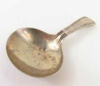 A silver caddy spoon of modest form, with borderin