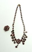 A Georgian flat cut garnet necklace, the central q