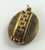 An oval Victorian locket, with a central chain mot