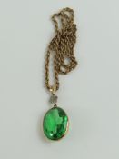 A green glass set pendant, with a diamond set dais