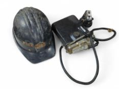 A black plastic miners hat complete with lamp and