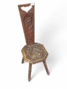 A carved oak spinning chair on bobbin turned suppo