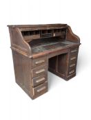 A 20th-century oak roll-top desk