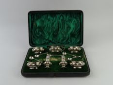 A cased silver cruet set, comprising four salt pot