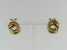 A pair of unmarked gold clip earrings, composed of