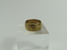 A wide 9ct gold patterned wedding band, finger siz
