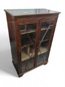 A 20th-century stained-mahogany display cabinet