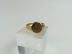 A signet ring, the round head engraved with a set