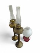 An oil lamp with tall brass column, another simila