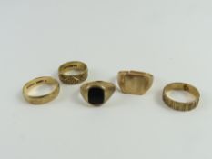 Three patterned 9ct gold wedding bands, a 9ct gold