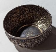A silver or silver-plated bowl with floral embossm