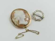 An orange and white shell cameo brooch, depicting