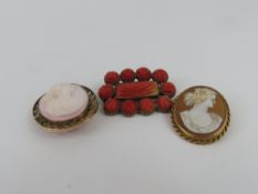 A Georgian brooch set with carved orange stones, p