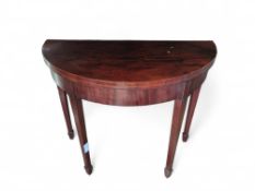 A 20th-century demi lune mahogany card table