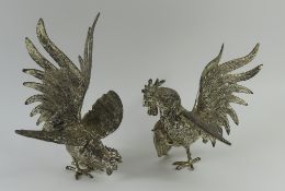 Two silver-plated models of fighting cocks, with d