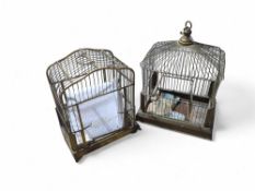Two birdcages each with white pottery feeder