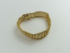 A 9ct gold bracelet, composed of rope and oval sha