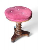 A 20th-century mahogany stool with rose velvet cus