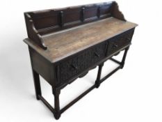 A possible reproduction oak sideboard upon five le