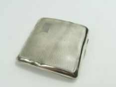 A small silver cigarette case with wavy decoration