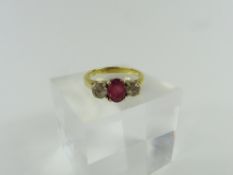 A ruby and white sapphire three stone ring, all cl
