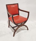 Early 20th century armchair with red leatherette upholstered seat and back, raised on front X-