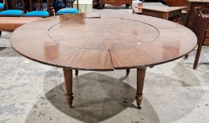 19th century figured mahogany large circular extending dining table, the circular top flanked by