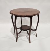 Edwardian mahogany occasional table with piecrust top above six scroll-shaped legs joined by a lower