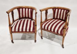 Pair of late 19th century tub-shaped upholstered library armchairs, upholstered with striped red