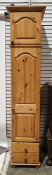 Modern tall pine narrow wardrobe, surmounted with a panelled cupboard and above two short drawers