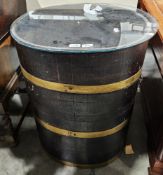 Antique coopered barrel adapted into a glass-topped occasional table of oval form, 70cm high x