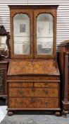 Queen Anne walnut bureau bookcase, the doors with bevelled edged mercury glass mirrors over two