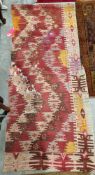Early 20th century Persian or Turkish kilim, woven with geometric zig-zag shaped bands in red, brown