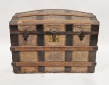 Late 19th/early 20th century tooled leather, oak and iron-banded travelling trunk, of domed form,