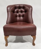 20th century leatherette upholstered club/tub chair with button back, raised on front cabriole legs,