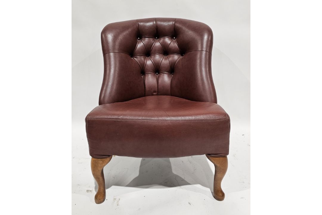 20th century leatherette upholstered club/tub chair with button back, raised on front cabriole legs,