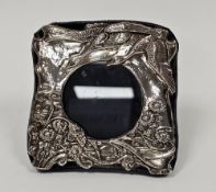 Contemporary silver-mounted photograph frame with embossed scene depicting swans flying over a