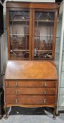 Reproduction mahogany bureau bookcase having astragal glazed doors and three adjustable shelves, the