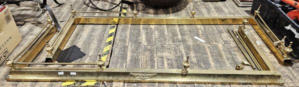 Two large brass fenders, each with urn finials, 180cm wide (2)