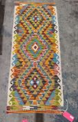 Chobi kilim runner having three chevron bordered lozenge medallions and hooked borders, 150cm x 63cm