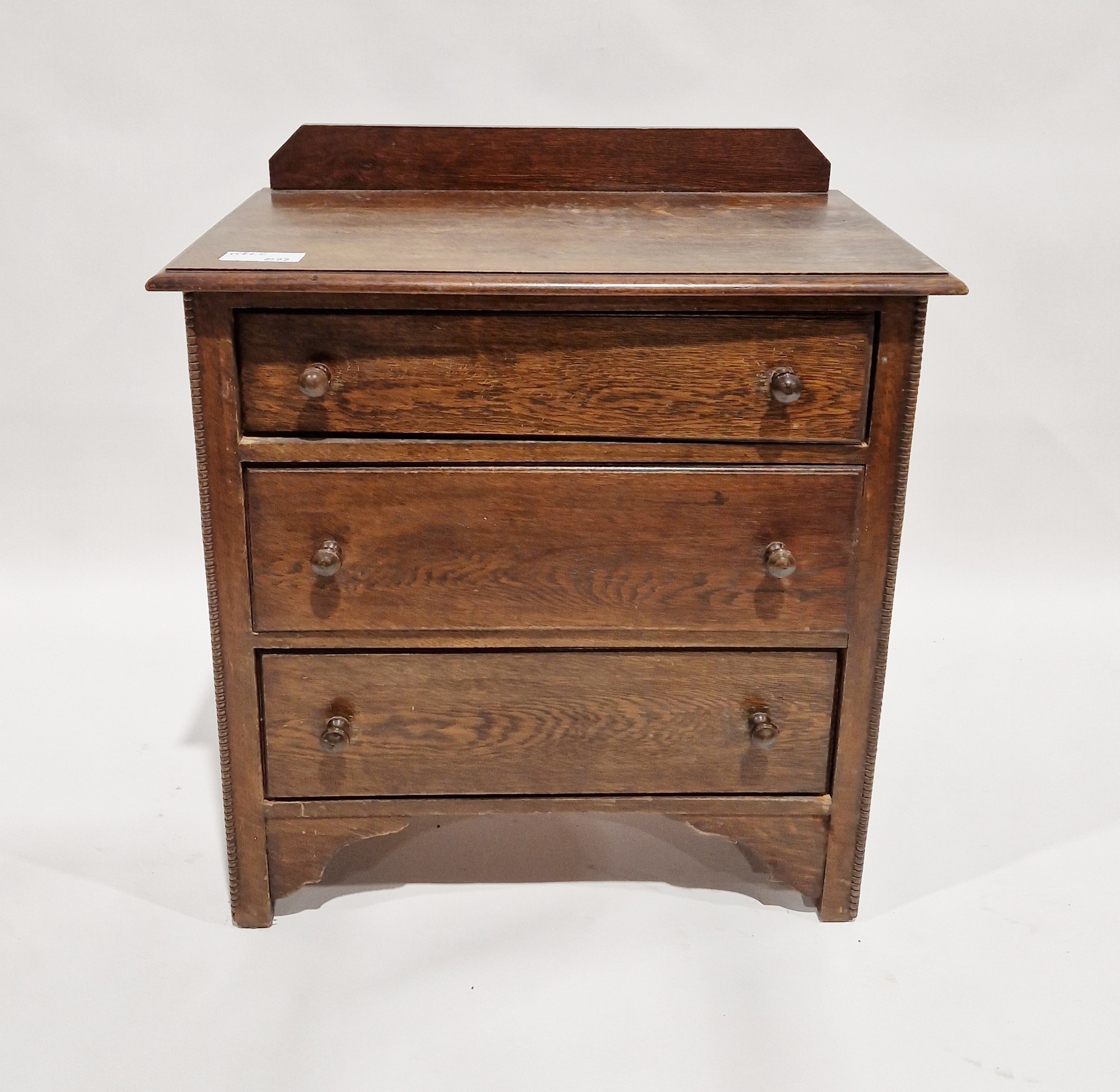 Early to mid 20th century oak chest of three long drawers, each with turned handles