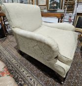 Victorian upholstered armchair on turned mahogany feet and brass castors, upholstered in cream