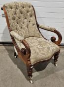19th century mahogany armchair with button back and scrolling arms, on turned front legs, with
