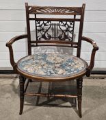 Late Victorian salon armchair, the back carved with lyre and berried foliate splat, with scroll