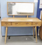 Ercol 'Windsor' range elm dressing table and chair, the rounded rectangular top mounted by