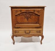 Contemporary oak storage cupboard, the fall front opening to reveal a storage compartment with