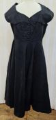 A white and black printed summer dress, with black velvet trim and openwork detailed with faux